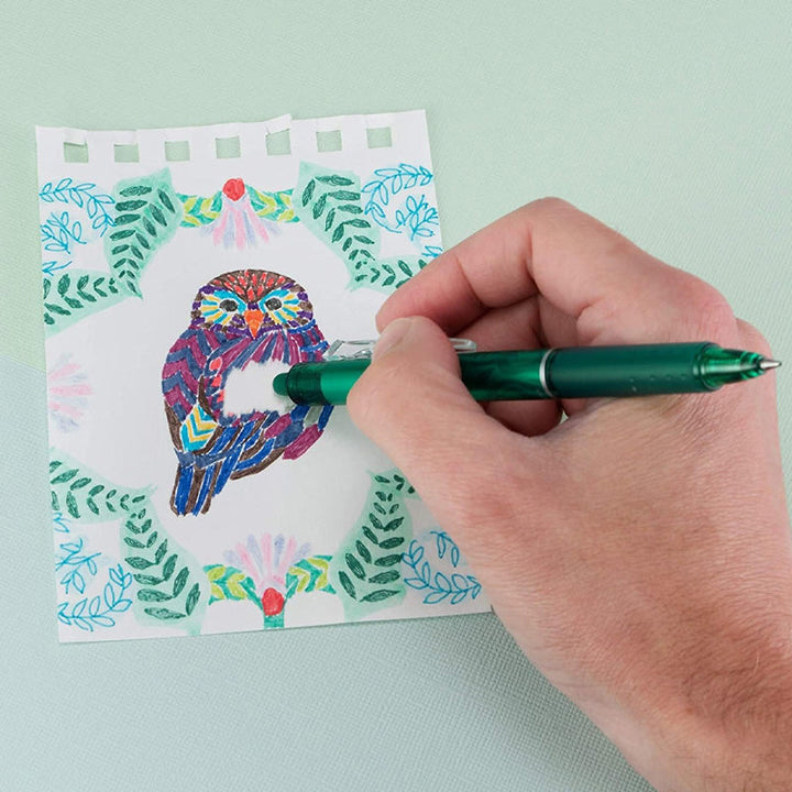 "Top down view of colorful erasable gel pens on white background with visible pen tips and vibrant colors."