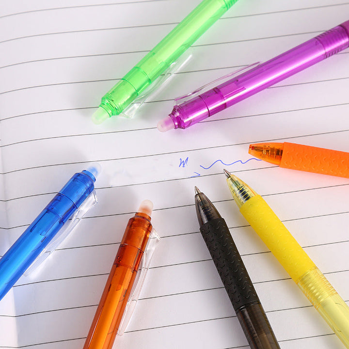 "Top down view of colorful erasable gel pens on white background with visible pen tips and vibrant colors."