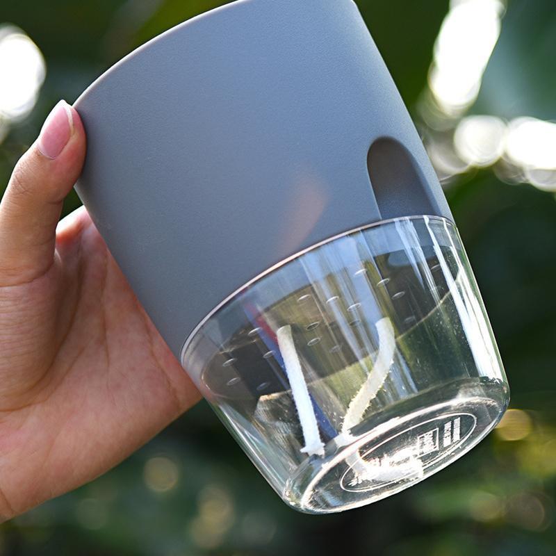 "Transparent självvattnande hydroponisk blomkruka, modern design med synliga rötter, idealisk för hem och kontor."