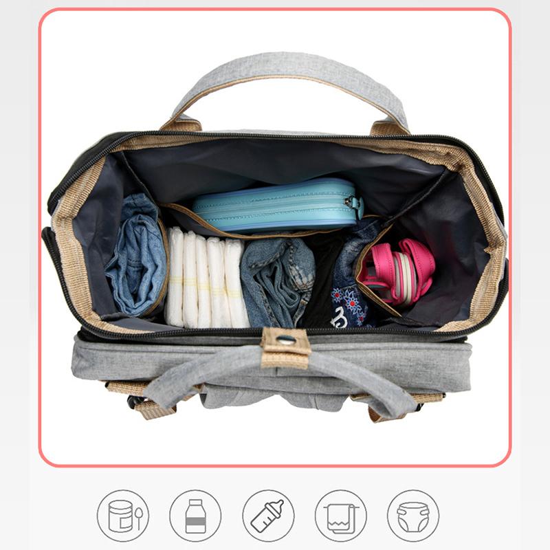"Unisex blöja ryggsäck med inbyggt skötbord, stort förvaringsutrymme och hållbart, vattentätt Oxford-tyg."