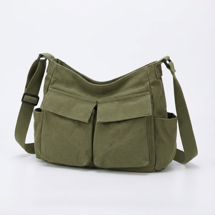 Unisex messenger väska i canvas med flera smarta ytterfickor. Smidig organisering för vardagen.