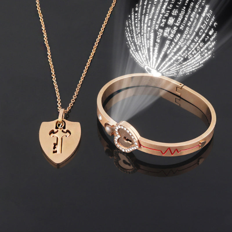 Unisex låsarmband och nyckelhalsband i titanstål, elegant design i stål och roséguld, stilfullt och hållbart smyckeset.