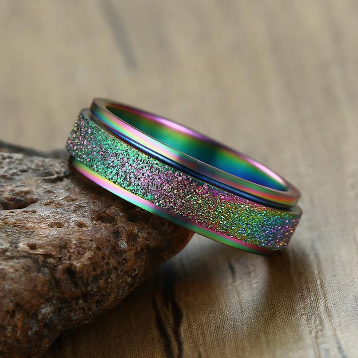 "Unisex sandblästrad roterande fidget ring i rostfritt stål, elegant och modern design, flera färger tillgängliga."