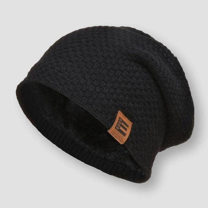En blå unisex beanie i våffelstickad design med värmande fleece, idealisk för kalla dagar.