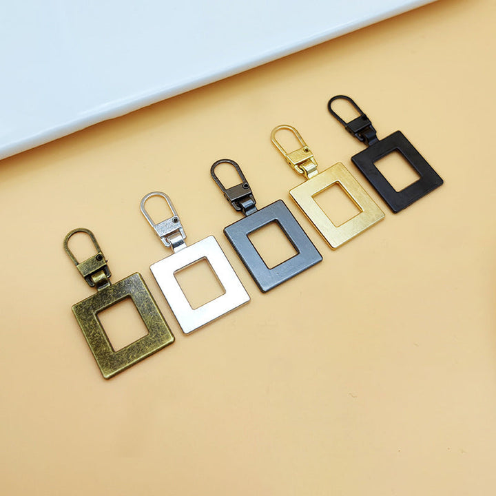 "Universalt avtagbart metallhandtag för dragkedjor, silver, perfekt för kläder och väskor, rektangulärt, robust design."