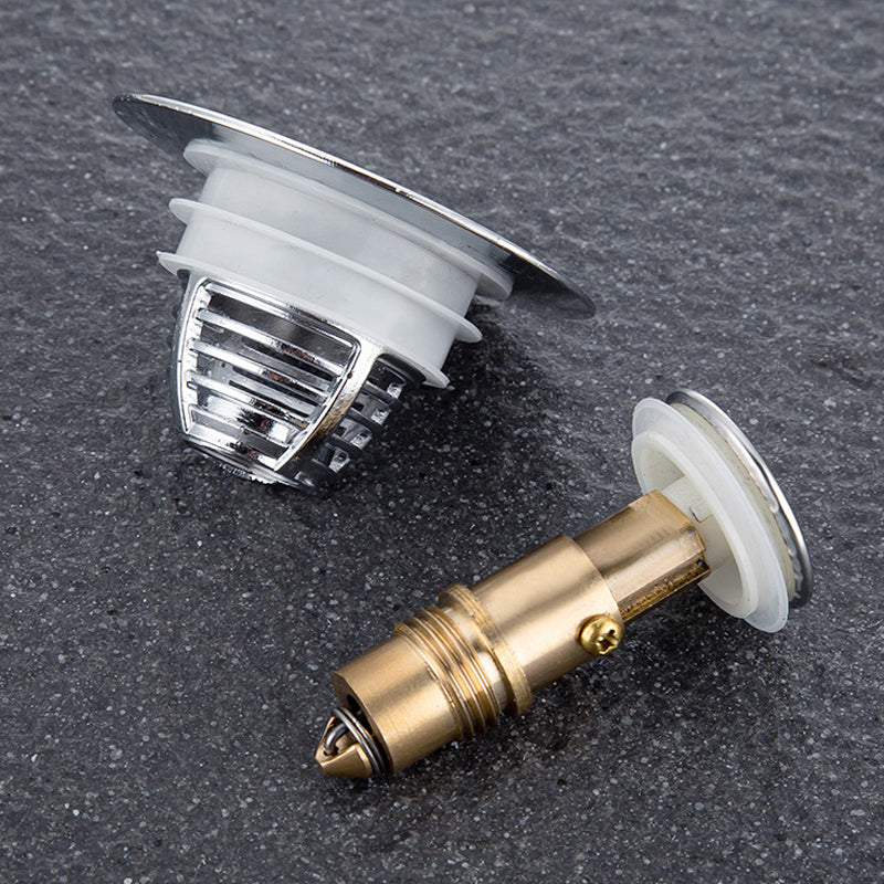 "Universell badrumsavloppspropp i elegant mässing och stål med tryckknapp, silikonringar för säker passform mot smuts."