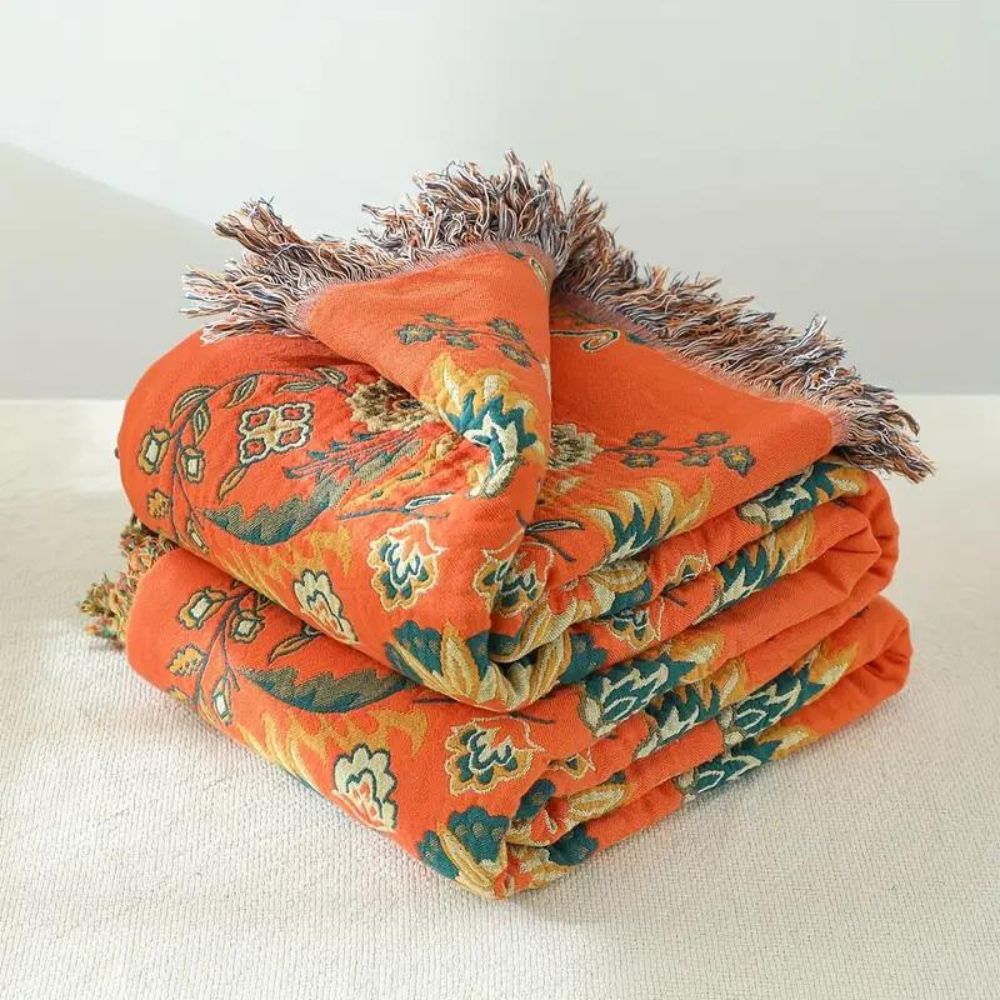 Mysig Marigold pläd, en vändbar flerfärgad filt som adderar värme och stil till din heminredning.