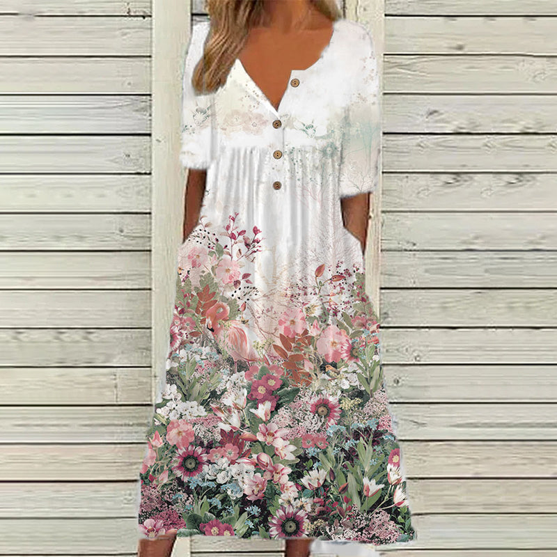 "V-ringad sommarklänning med blomtryck, elegant hög midja och flytande lång kjol, perfekt för soliga dagar."