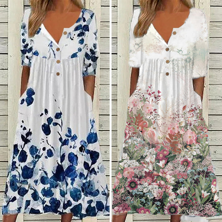 "V-ringad sommarklänning med blomtryck, elegant hög midja och flytande lång kjol, perfekt för soliga dagar."