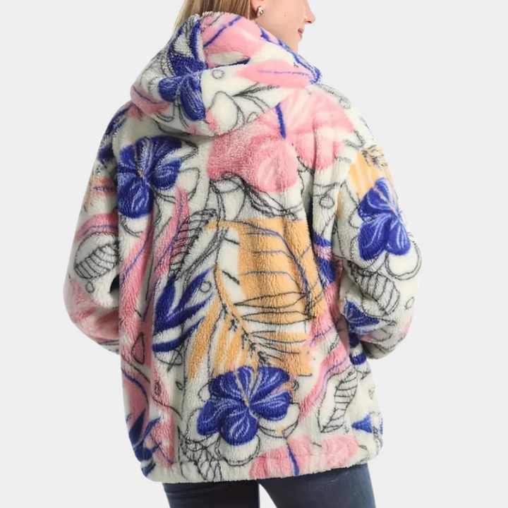 Elegant höstjacka för dam med huva och detaljerat blommönster. Varmt ytterplagg i stilren design.