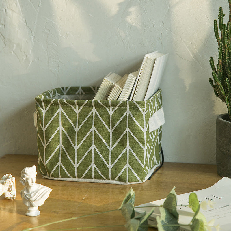 "Vikbar canvas förvaringslåda med tecknad design, i grått och vitt, perfekt för organisering av leksaker och kläder."