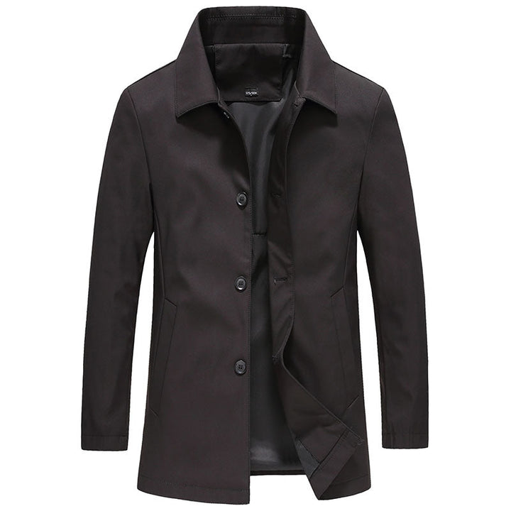 Elegant enfärgad herrjacka, lång och vindtät. Ytterkläder i stilrent höstmode, perfekt för blåsiga dagar.