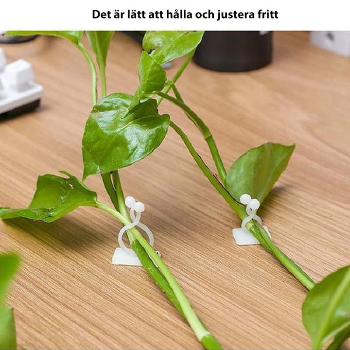 "Vit väggklämma för klätterväxter, stark och kompakt plastfäste, används för att ordna växter eller kablar på vägg."